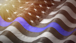 U.S. flag in black and white with one blue stripe across the middle.