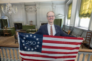 Sen. Hutchinson pictured with an America 250 Flag