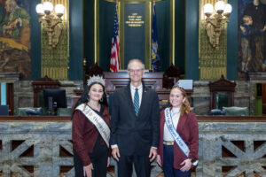 Senator Hutchinson Alt Text Venango County Fair Queen, Avery Metz, and Butler County Fair Queen, Rylee Colteryahn, smiling for a photo in the Pennsylvania Senate Chamber.